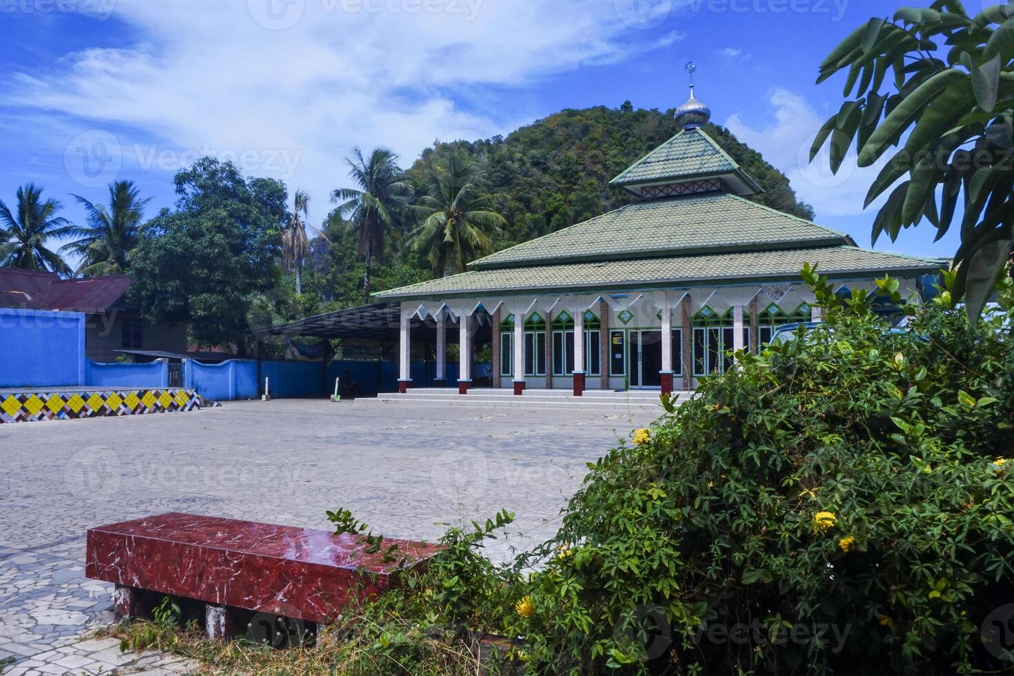view of the mosque with a wide expanse of mountains and blue sky photo