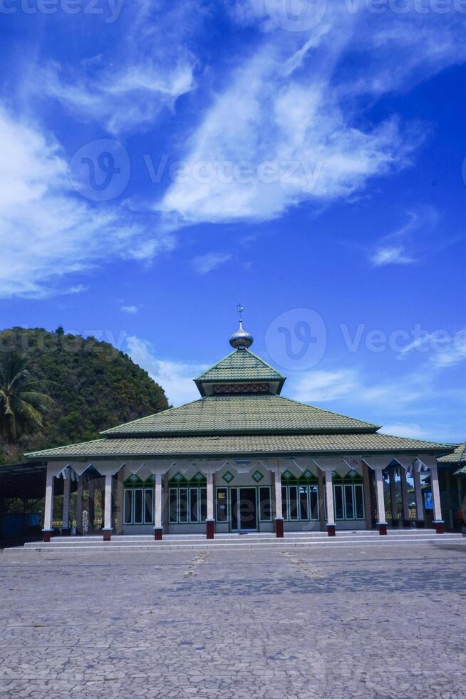 view of the mosque with a wide expanse of mountains and blue sky photo