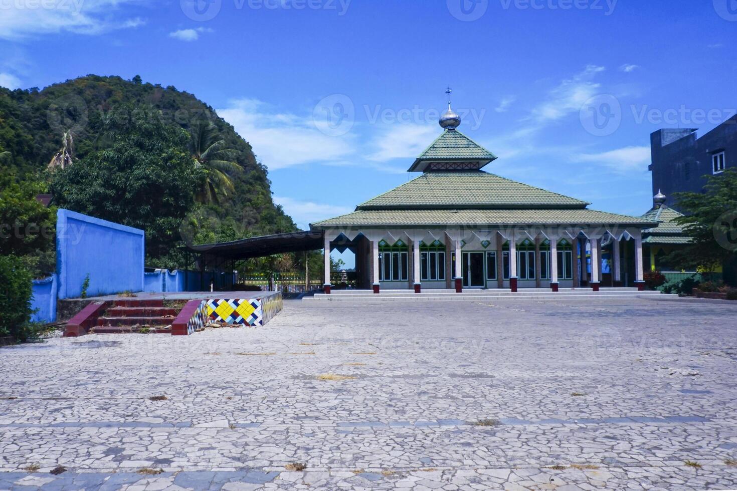 view of the mosque with a wide expanse of mountains and blue sky photo