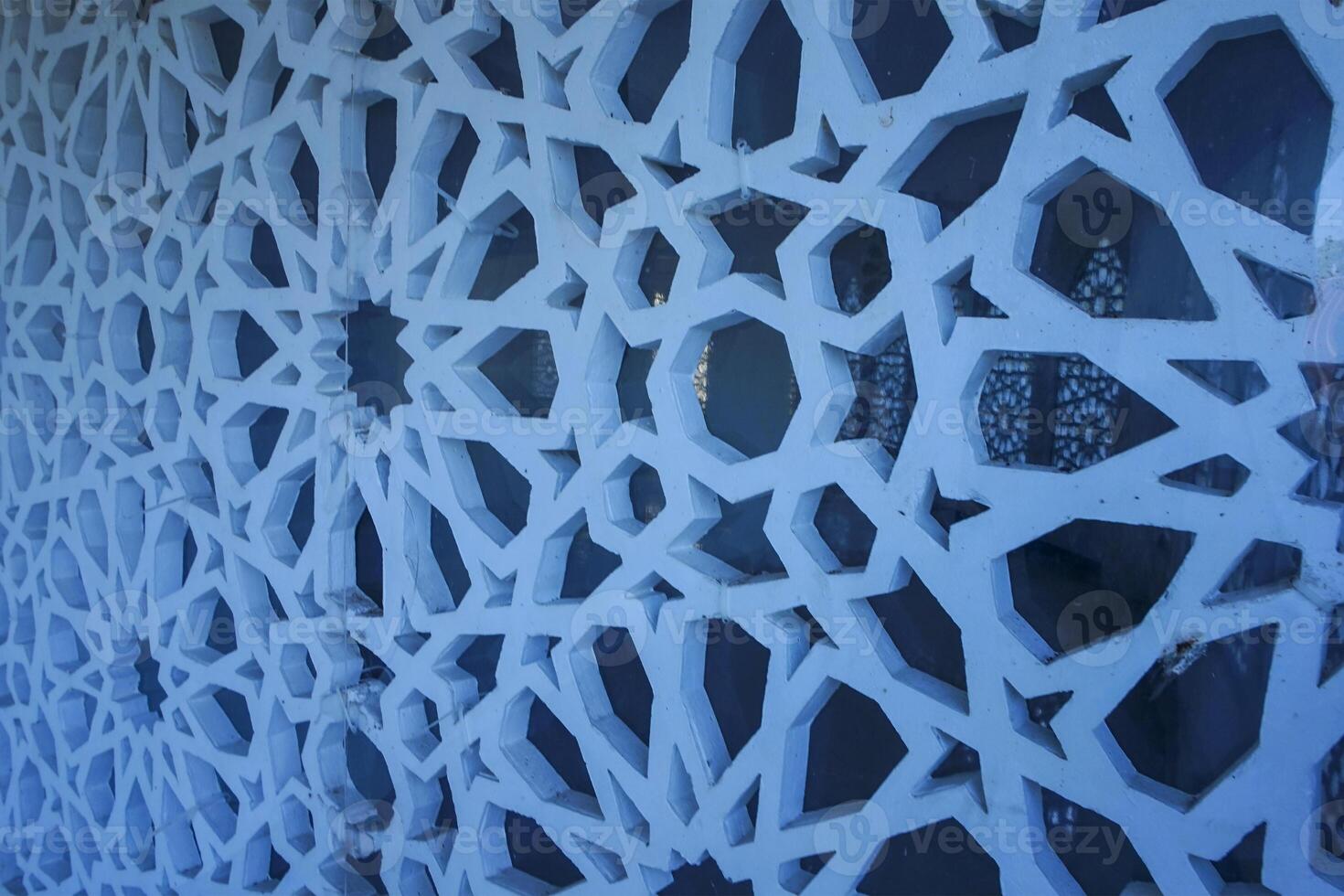 Artistic photo of a mosque wall which has the impression of Islamic religious symbols