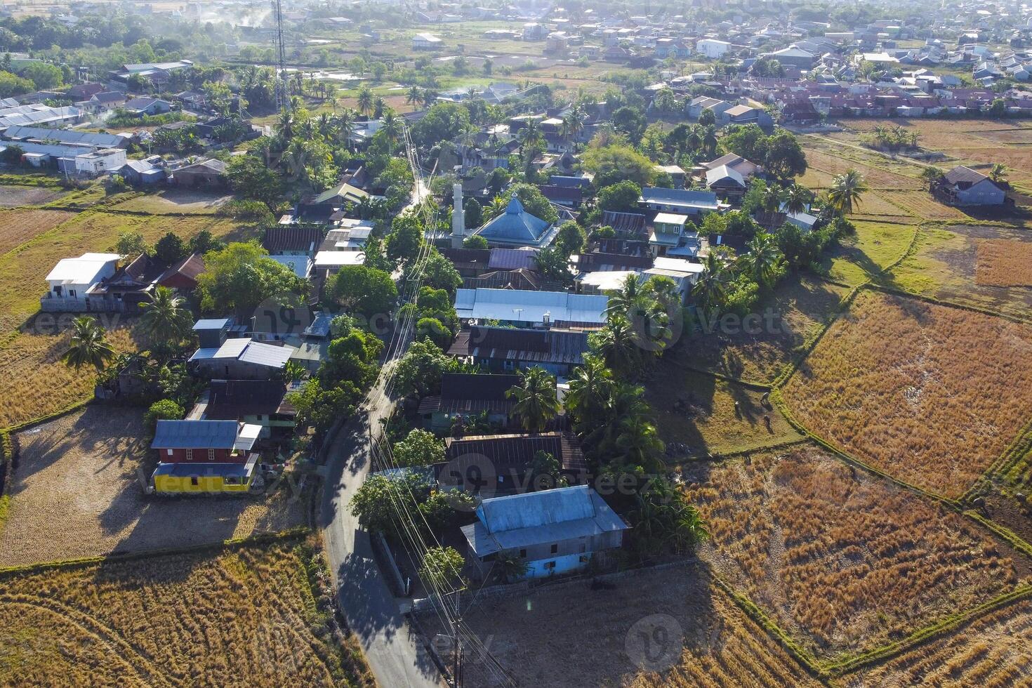 Photos of views of villages and rice fields during the dry season are displayed