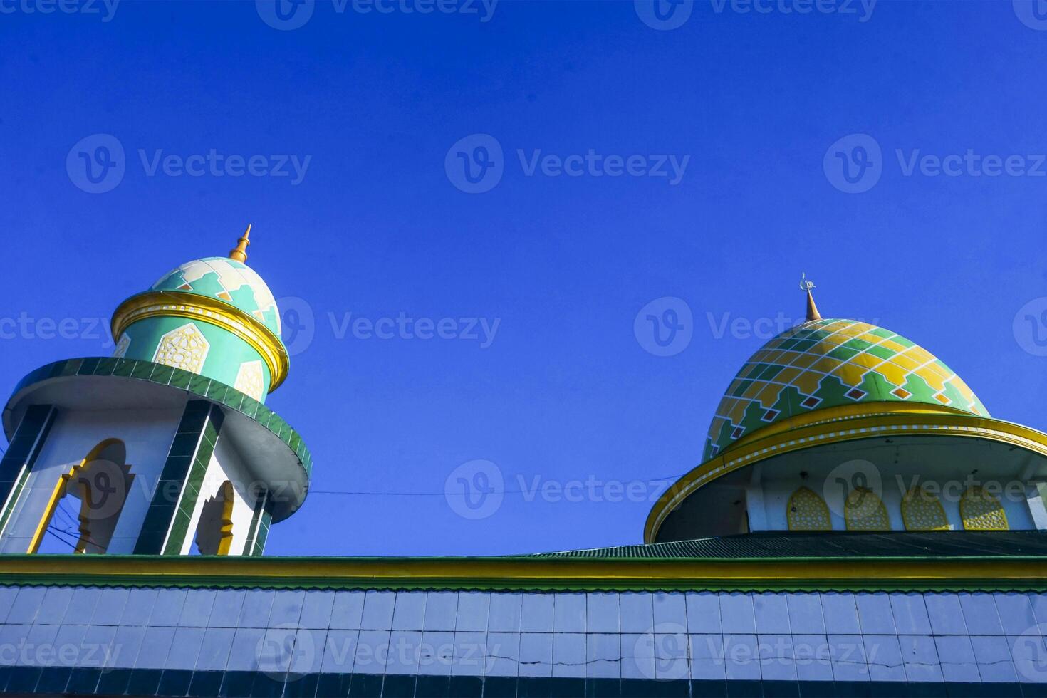 view of the dome and minarets of the mosque, against the blue sky photo