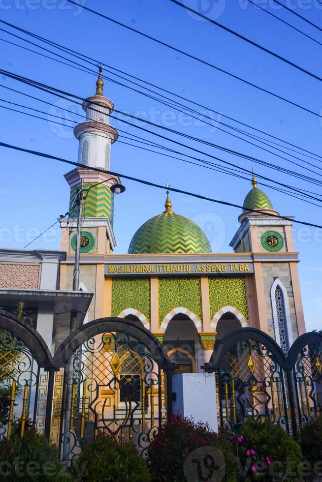 The splendor of the mosque and its towering minaret under the blue sky creates a stunning view photo