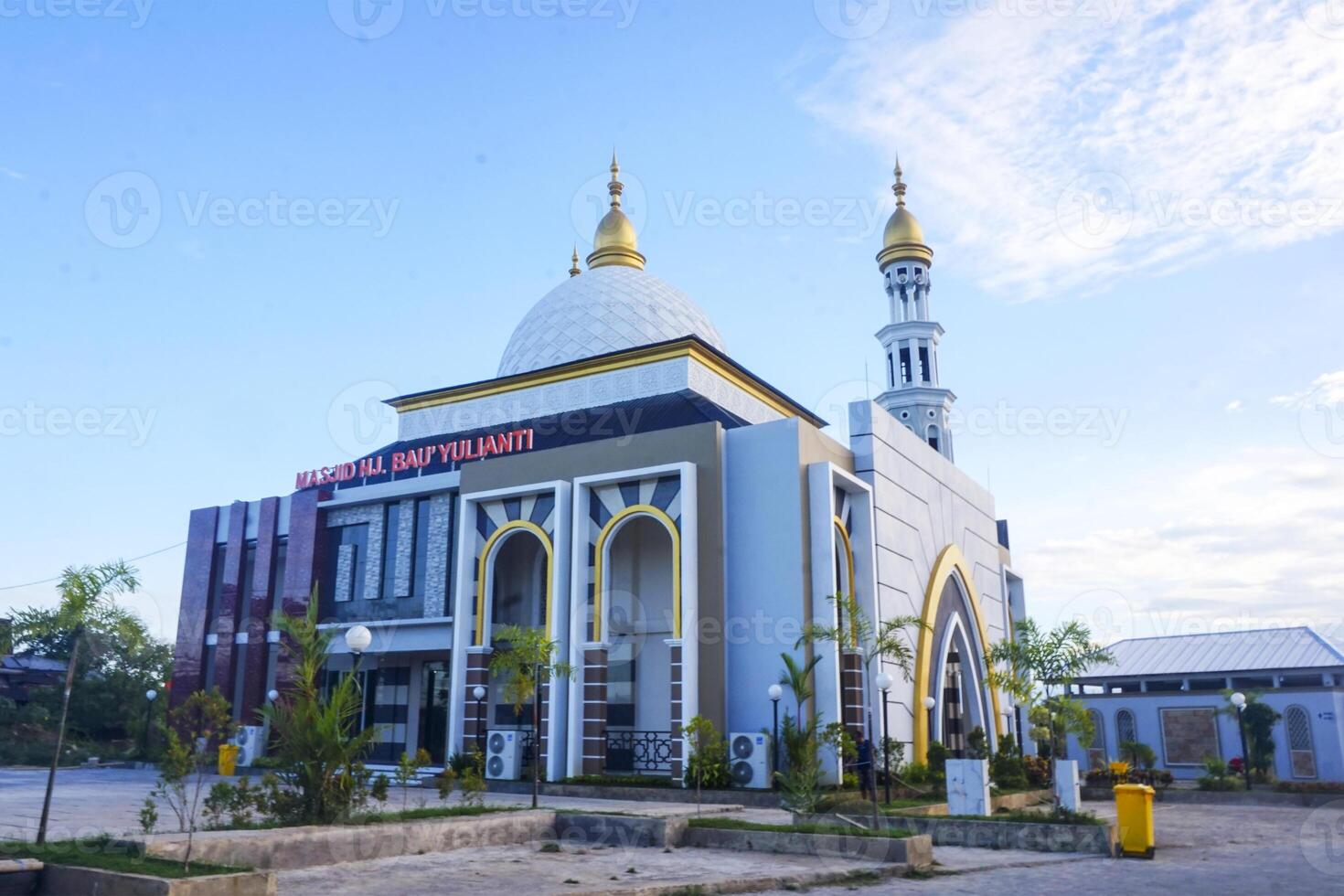 The splendor of the mosque and its towering minaret under the blue sky creates a stunning view photo