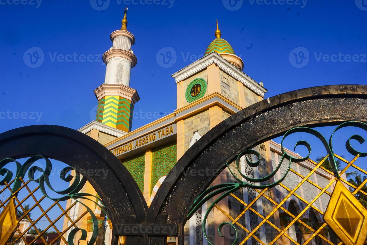 The splendor of the mosque and its towering minaret under the blue sky creates a stunning view photo