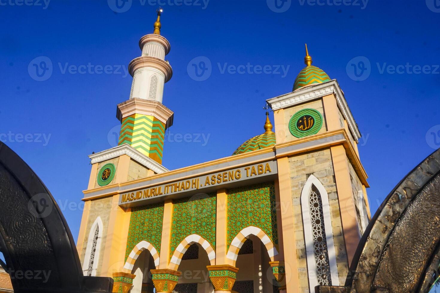The splendor of the mosque and its towering minaret under the blue sky creates a stunning view photo