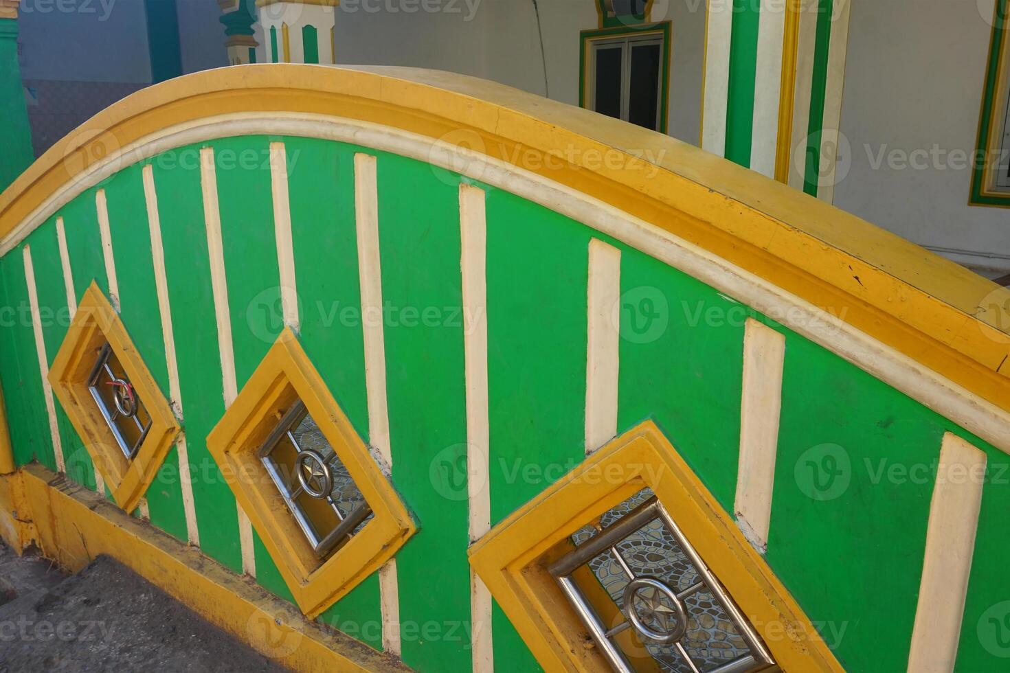 the texture of the mosque fence is green and yellow during the day photo