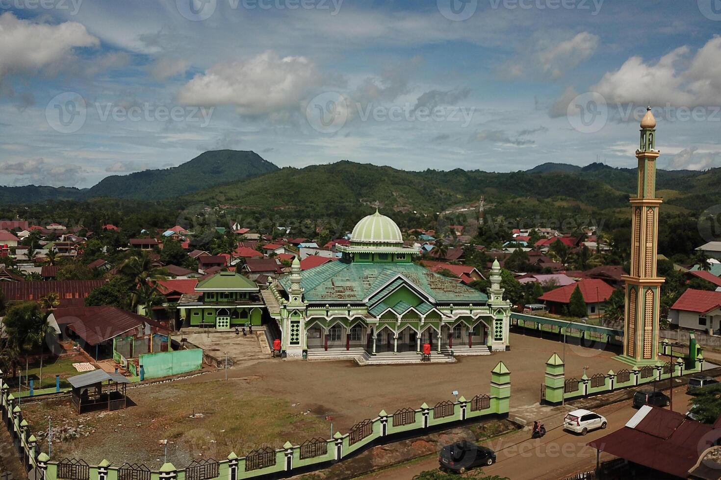 panorama of the mosque in the middle of the countryside with a backdrop of sky and mountains photo