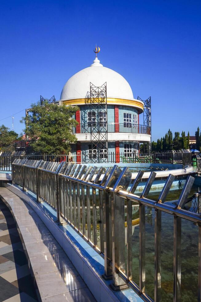 View of a mosque and its dome with a garden in its yard, the view of the mosque and its dome looks out, creating a stunning view photo