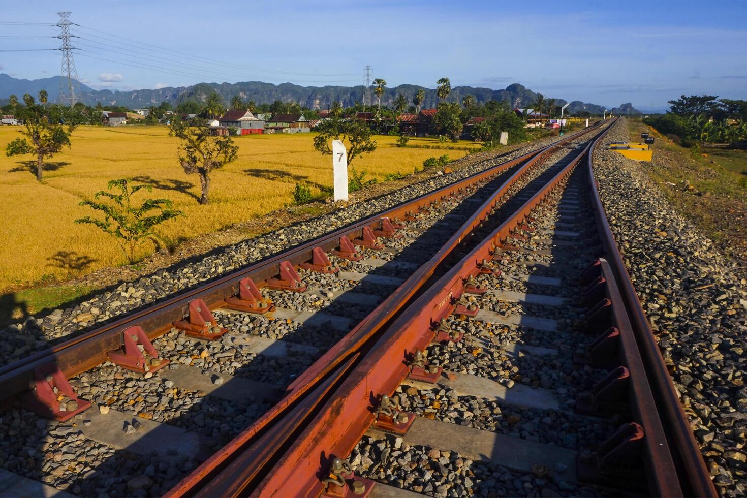 The view of the train tracks in the morning in rural Indonesia creates a romantic atmosphere photo