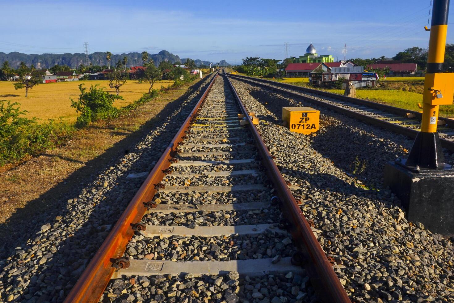 The view of the train tracks in the morning in rural Indonesia creates a romantic atmosphere photo