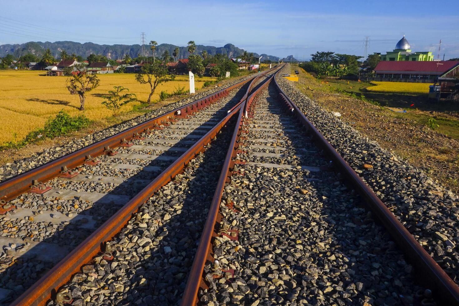 The view of the train tracks in the morning in rural Indonesia creates a romantic atmosphere photo
