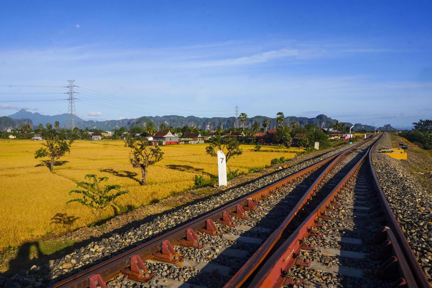 The view of the train tracks in the morning in rural Indonesia creates a romantic atmosphere photo