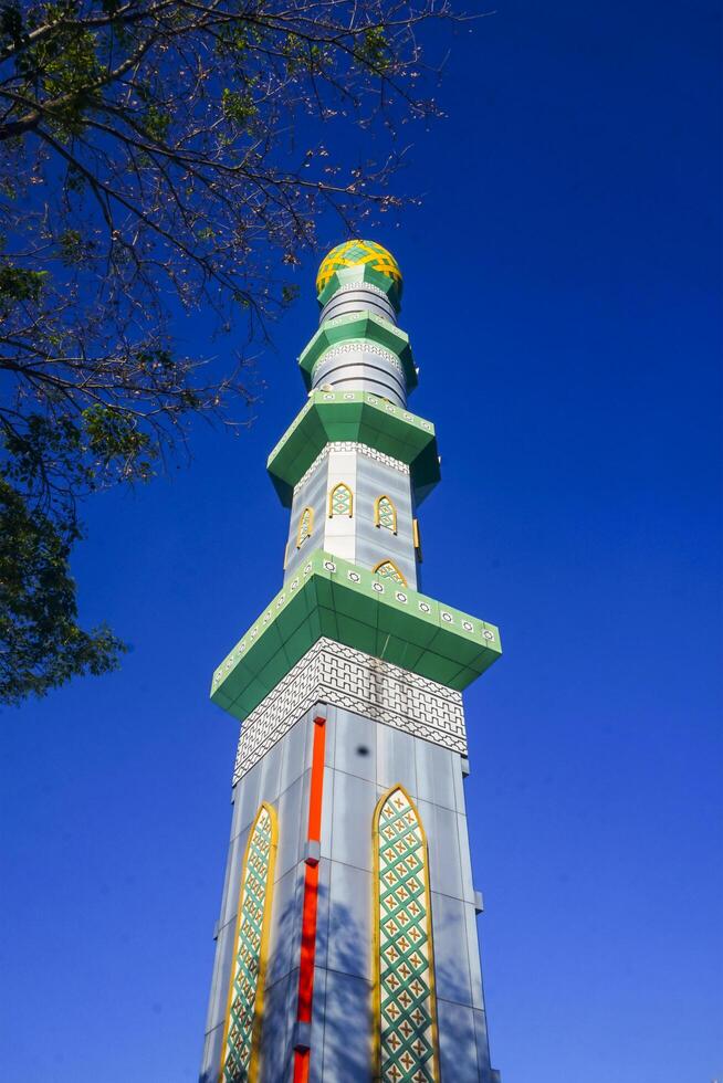 The mosque's minaret rises high against the blue sky, adding to the atmosphere of majesty photo