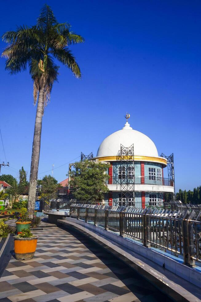 View of a mosque and its dome with a garden in its yard, the view of the mosque and its dome looks out, creating a stunning view photo