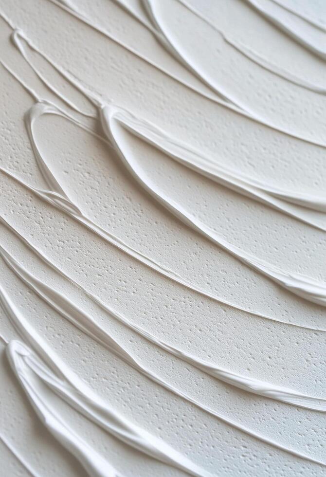 White paint smeared on a clean surface with a cap beside it photo