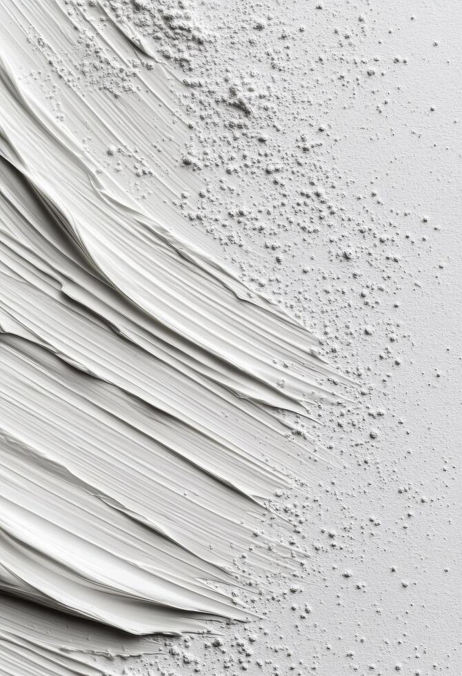 White paint smeared on a clean surface with a cap beside it photo