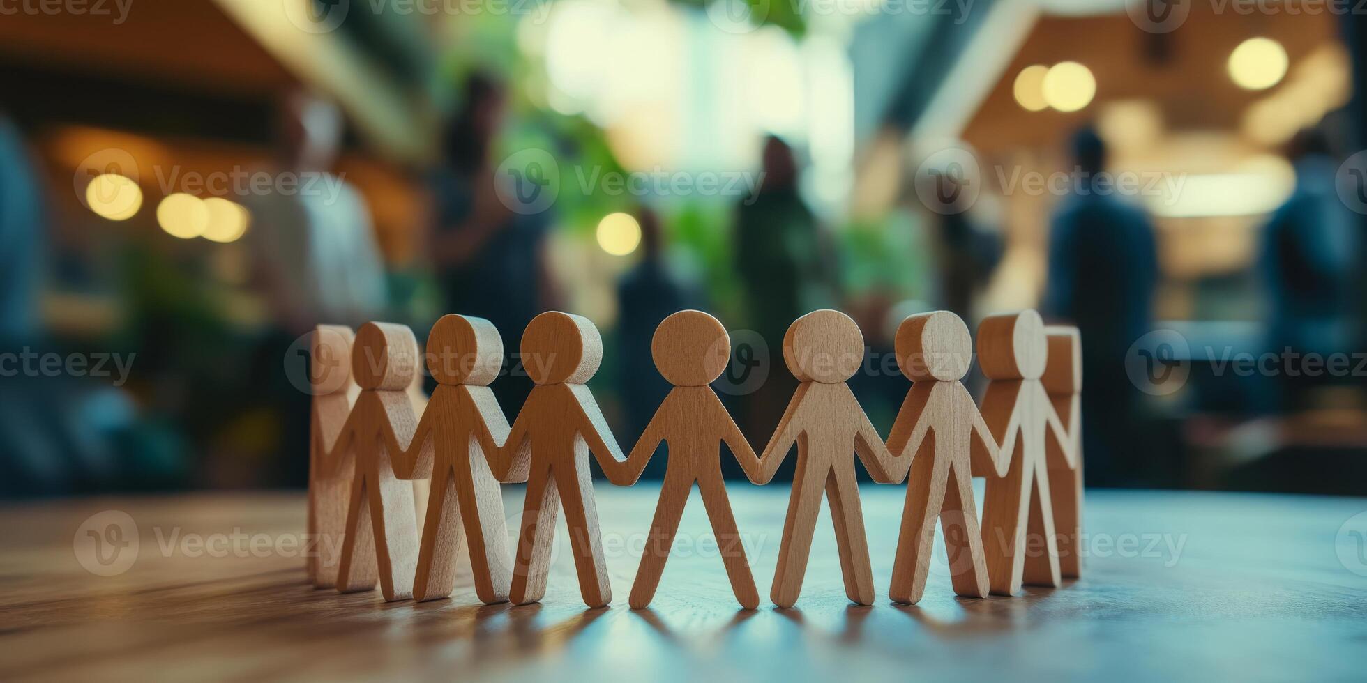 Wooden human figures standing together in a close circle symbolize the essence of teamwork, unity, and a strong sense of community spirit that thrives among all individuals who are involved photo