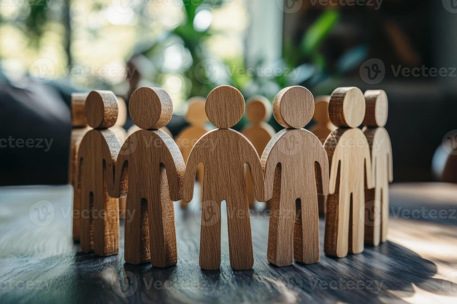 A circle of carved wooden figures symbolizes teamwork, unity, and community values, showcasing the importance of collaboration and togetherness to achieve common goals and embody cooperation photo