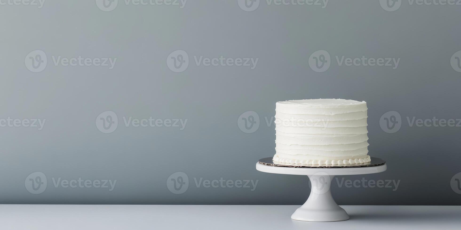 A simple yet elegant white birthday cake on a lovely stand makes the perfect centerpiece for any celebration. Its minimalistic design enhances its charm, making it a delightful treat for all photo