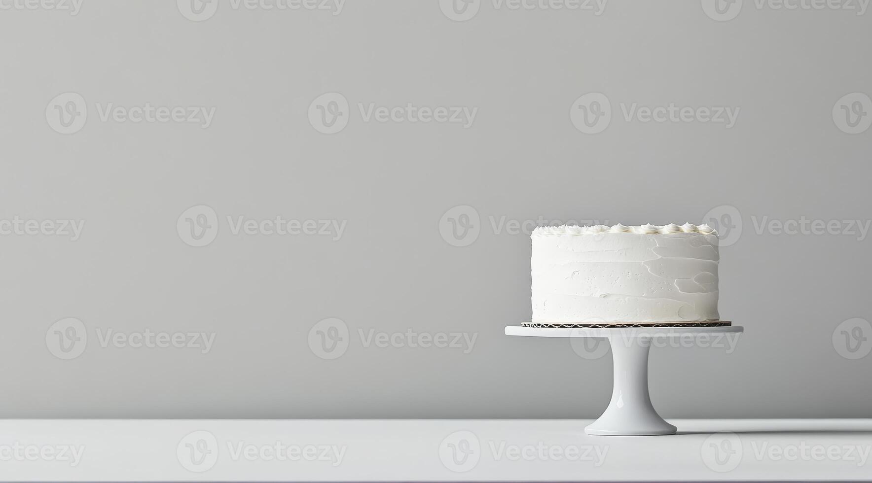 A beautifully simple white birthday cake, which has been elegantly displayed on a classic cake stand, is set against a neutral backdrop, creating a fresh and modern aesthetic that is truly appealing photo