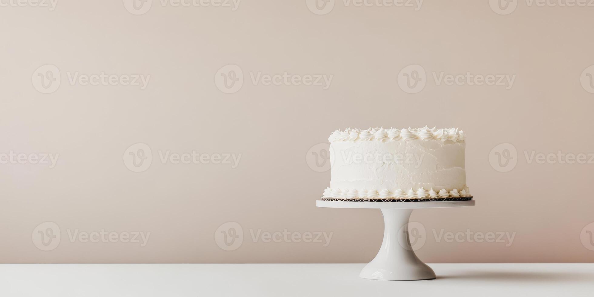 This is a beautifully minimalistic white birthday cake that is elegantly displayed on a lovely and simple cake stand, which is set against a soft and charming background that enhances its appearance photo