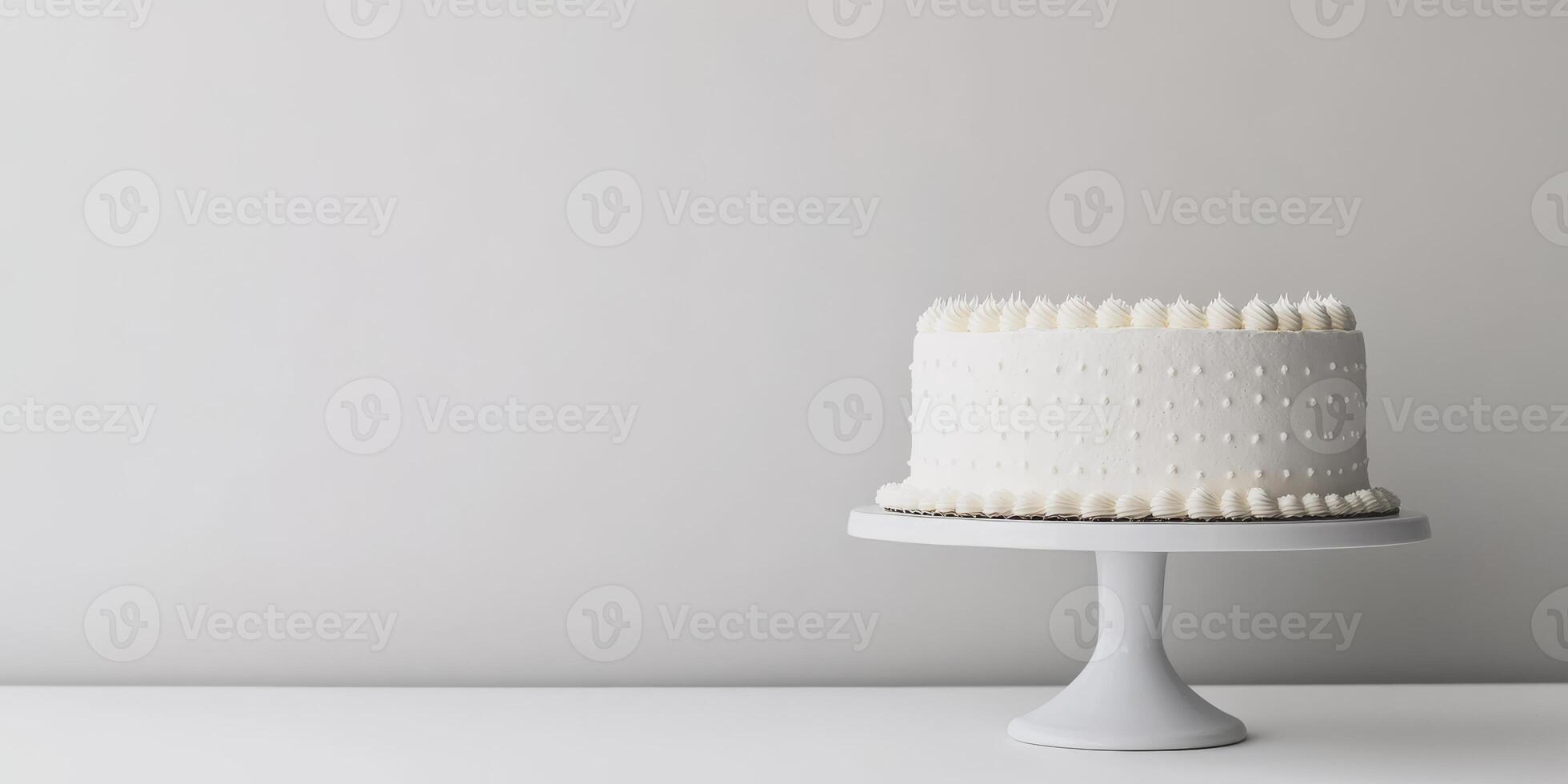A beautifully designed minimalistic white birthday cake is gracefully displayed on a stylish cake stand, making it the perfect centerpiece for any joyful celebration and special occasion, indeed photo