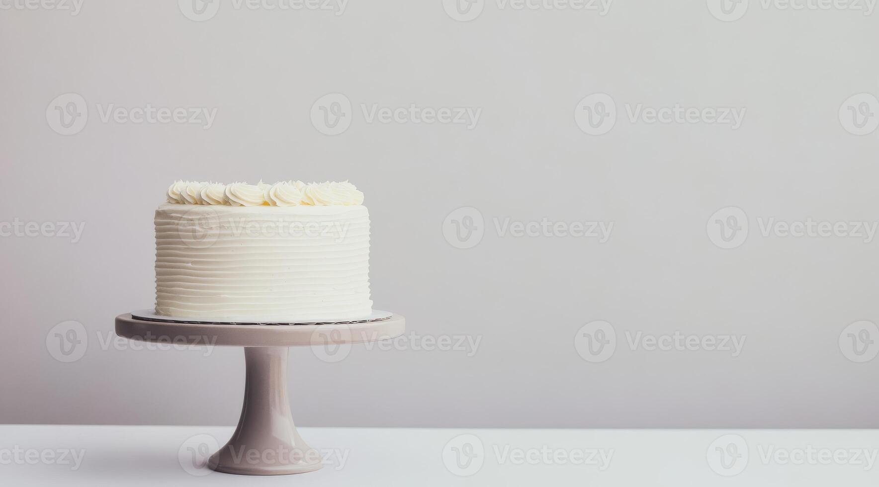 A lovely and simple, yet elegant white birthday cake presented beautifully on a charming cake stand, set against a neutral background, making it perfect for minimalist and refined celebrations photo