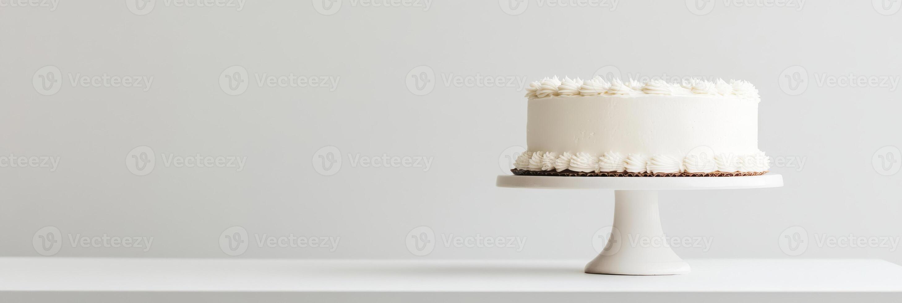 A stunningly minimalistic white birthday cake, elegantly and thoughtfully placed on a beautiful cake stand, making it the perfect centerpiece for any kind of celebration or joyous occasion photo