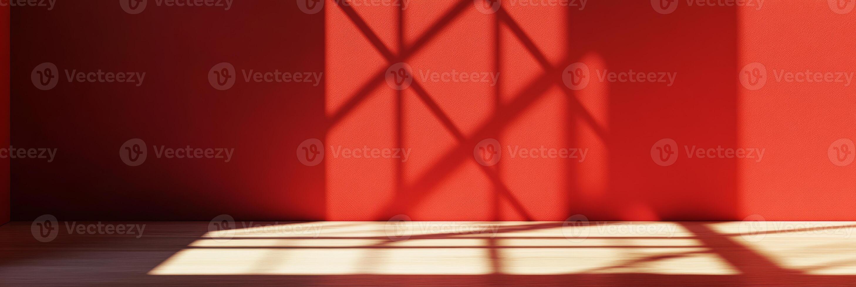 A vibrant red wall beautifully casting intricate shadows, creating an artistic play of light and design photo