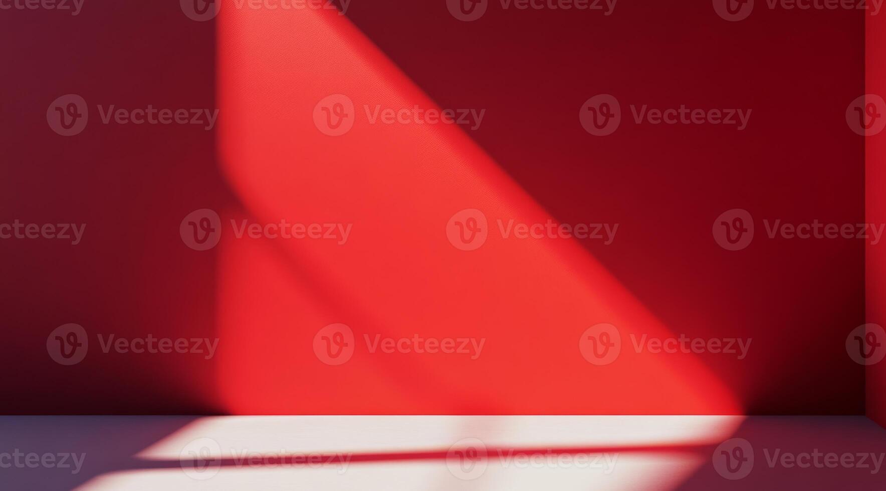 A strikingly vivid red wall, softly illuminated by gentle shadows, perfect for modern and contemporary design themes photo