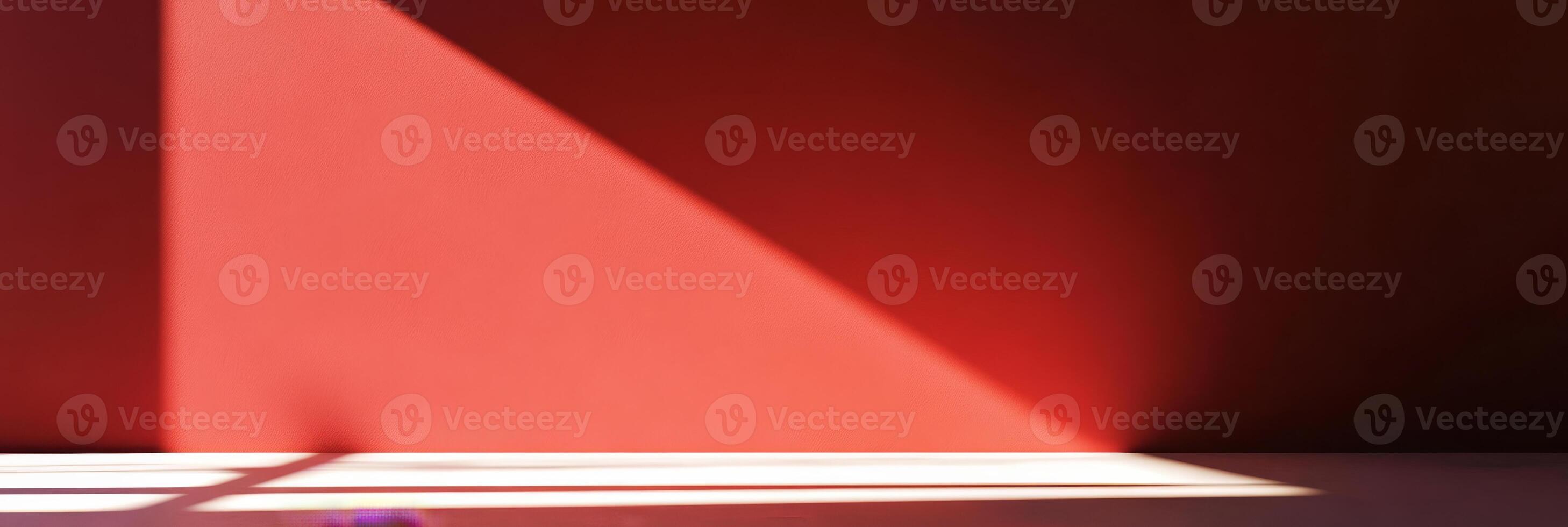 A striking light and shadow interplay contrasts against a vibrant red wall, perfect for modern design themes photo