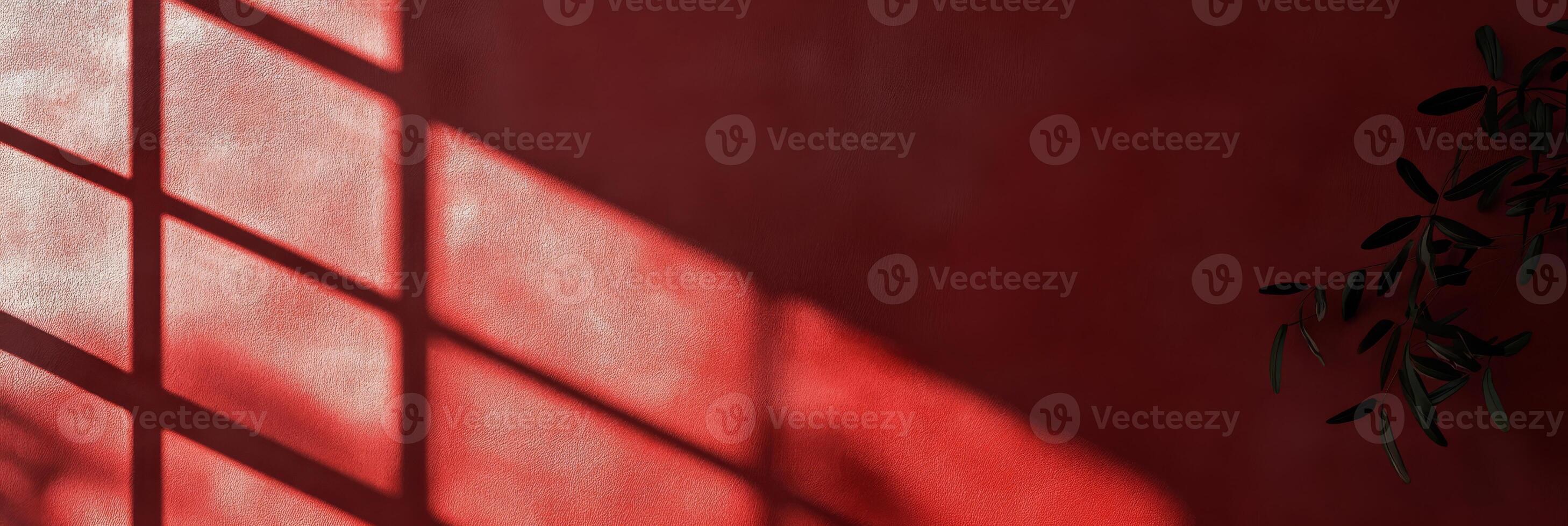 An eyecatching and striking interplay of contrasting shadows and vibrant light against a vivid red backdrop photo