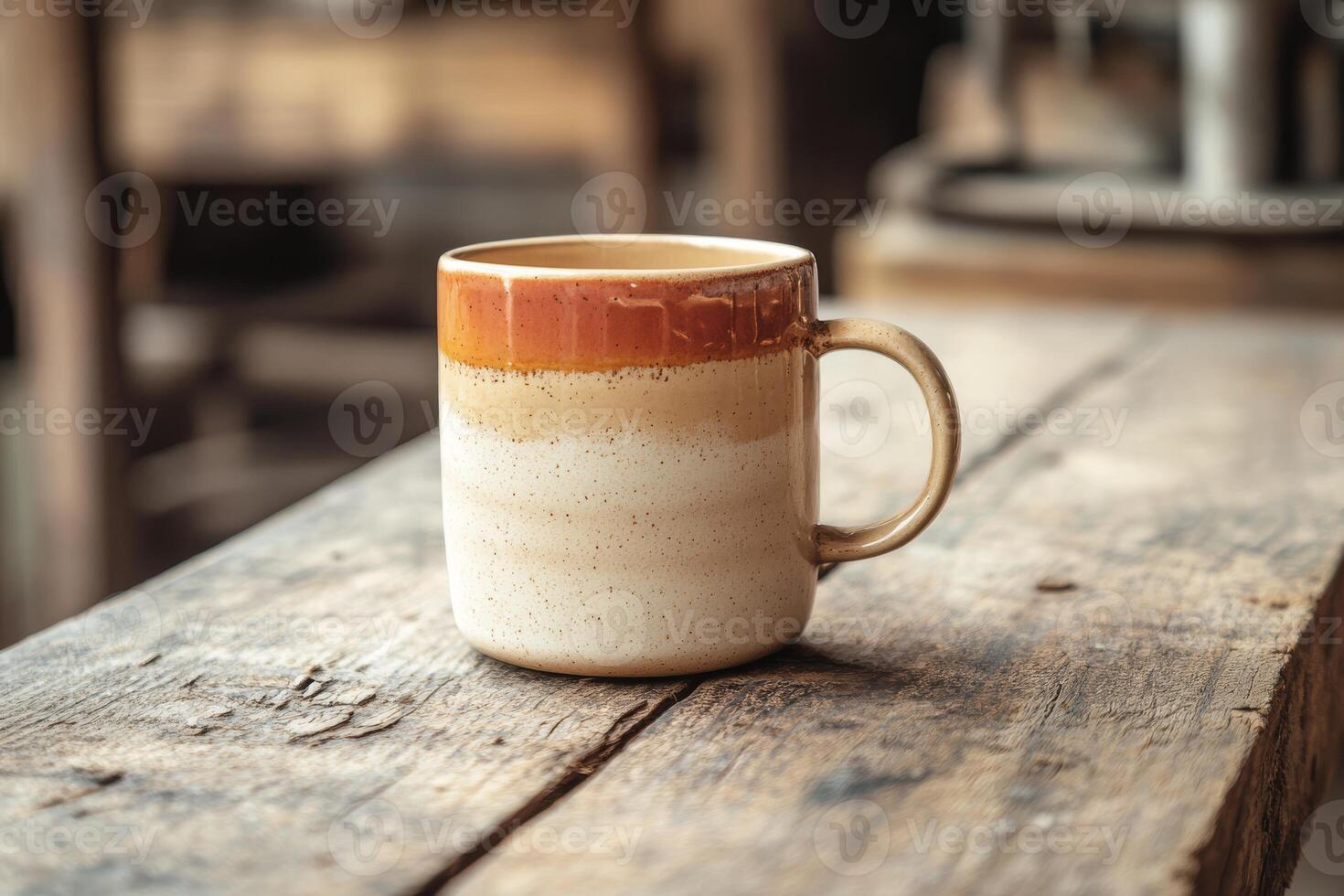 Explore this beautifully handcrafted ceramic coffee cup, showcasing warm earthy tones against a rustic wooden background. It adds charm to your beverage experience, enhancing every sip photo