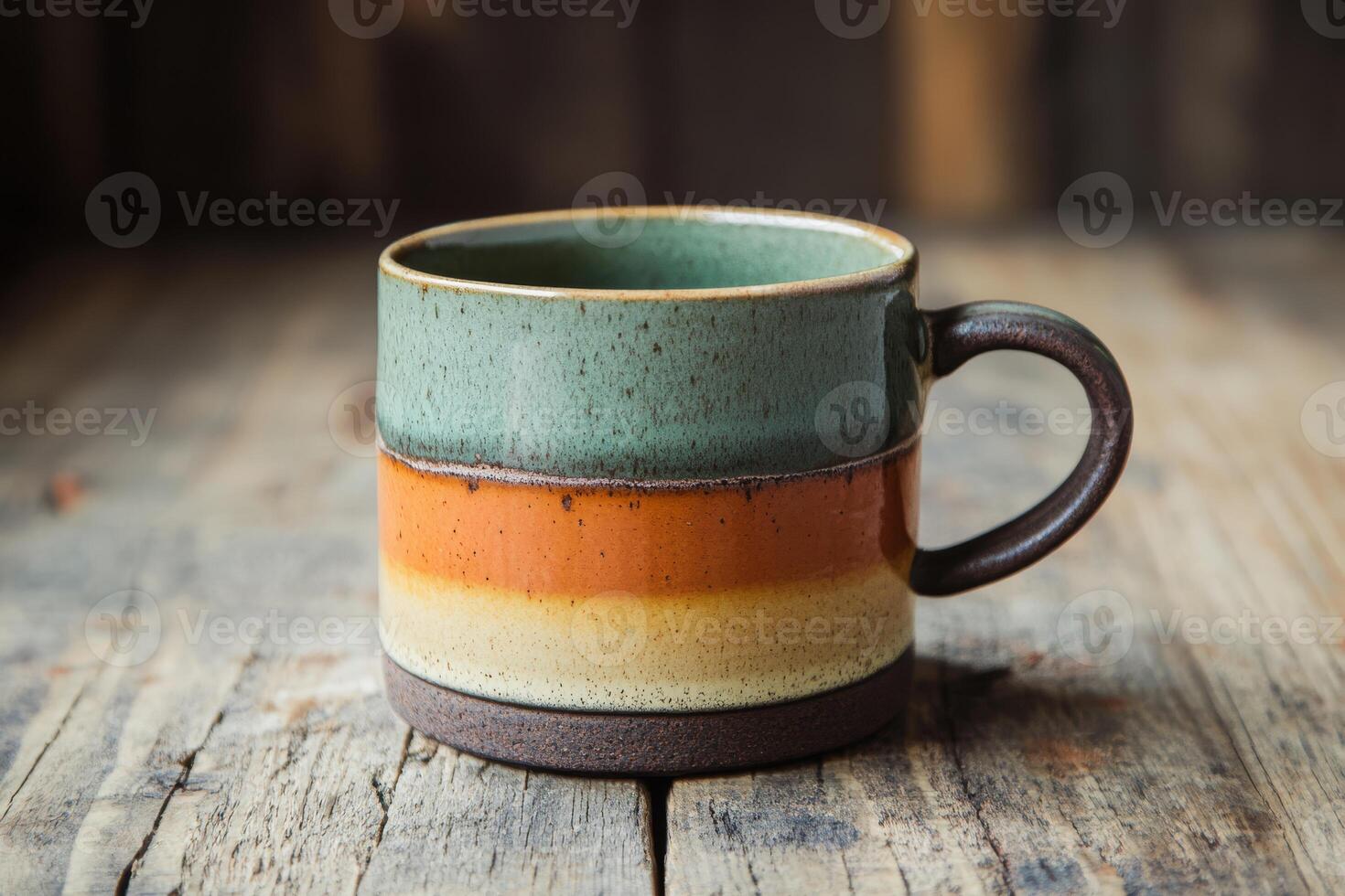 This ceramic coffee cup features earthy tones of green, orange, and beige, perfect for enjoying hot or cold drinks and enhancing your coffee experience with every aesthetically pleasing sip photo