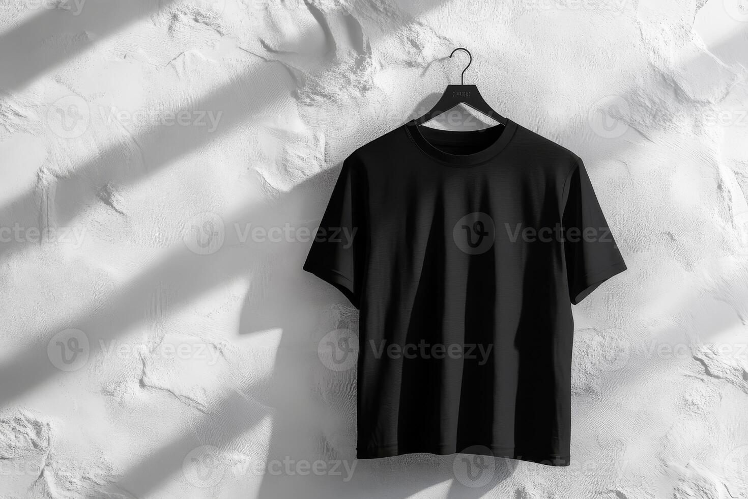 A stylish black tshirt elegantly displayed on a hanger, showcasing a minimalistic design with subtle textures photo