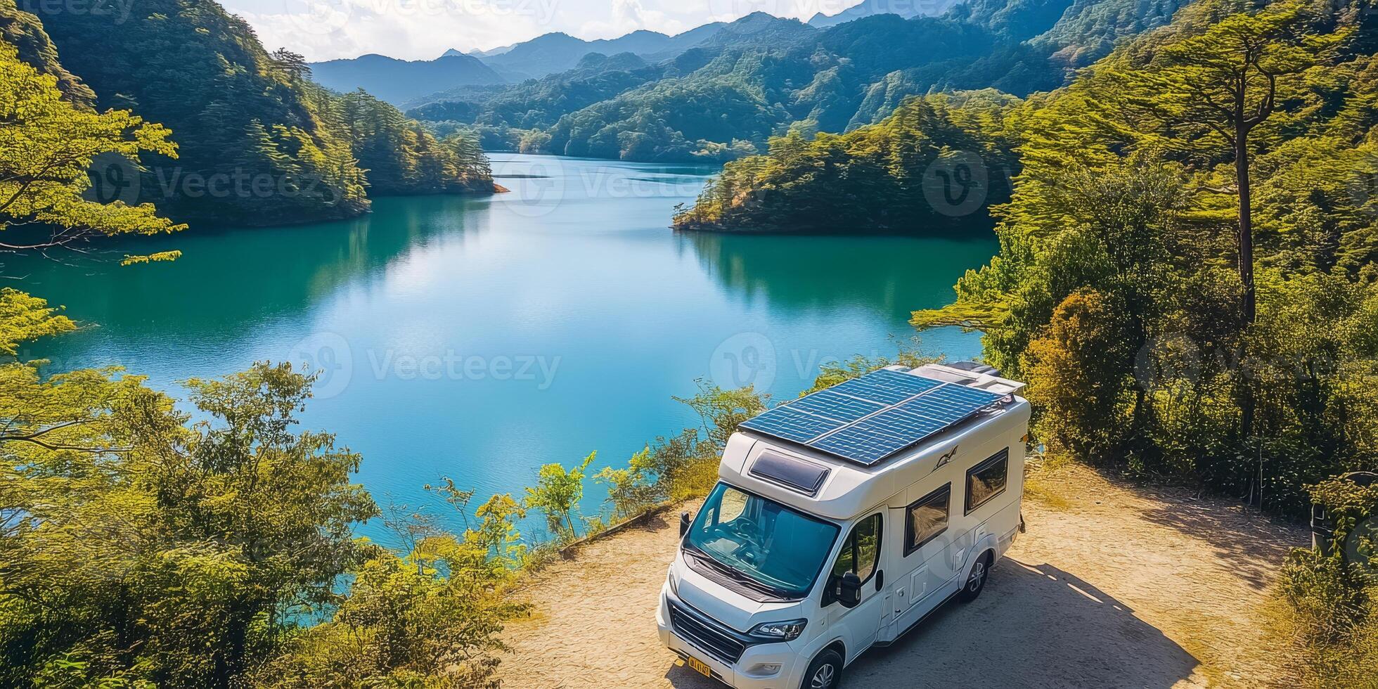 A cozy campervan is parked by a serene lake surrounded by majestic mountains and trees, showcasing sustainable travel powered by solar energy, inviting travelers to enjoy nature and the outdoors photo