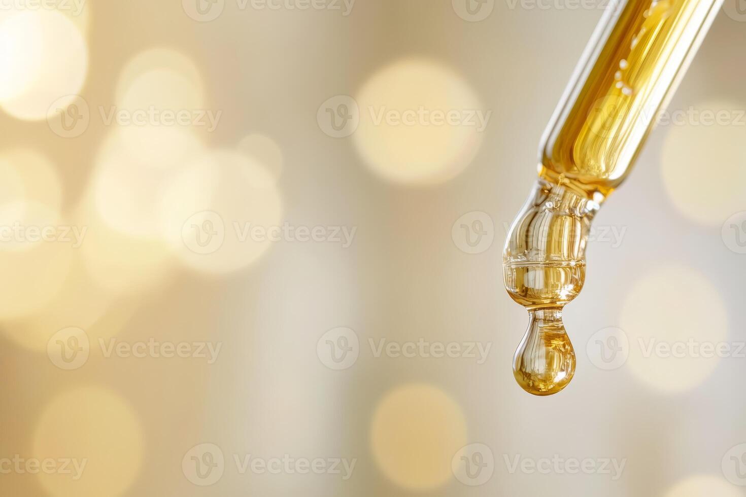 A detailed closeup image shows a pipette elegantly dropping a golden serum against a beautifully shimmering background photo