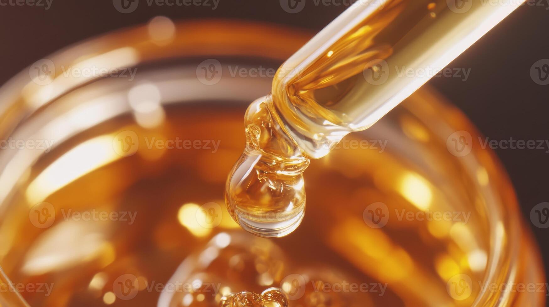 A dropper elegantly releases a rich golden liquid into a jar, showcasing its purity and luxurious texture photo