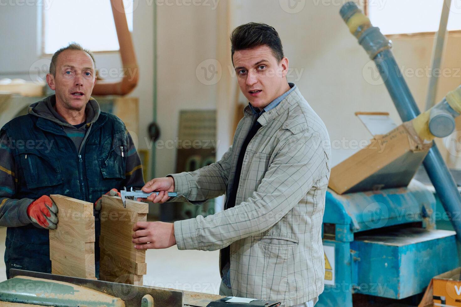 Production Manager Demonstrating Woodcraft Techniques to Employee for Decorative and Residential Items photo