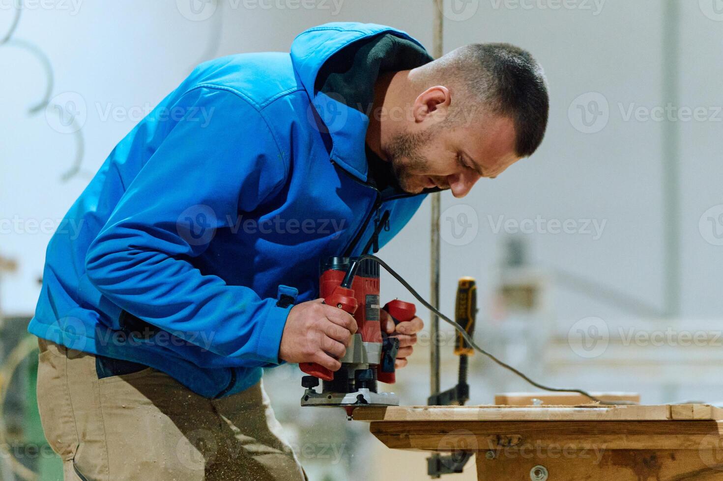 Close Up of Worker Carefully Cutting and Planing Wooden Pieces for Furniture in Wood Industry photo