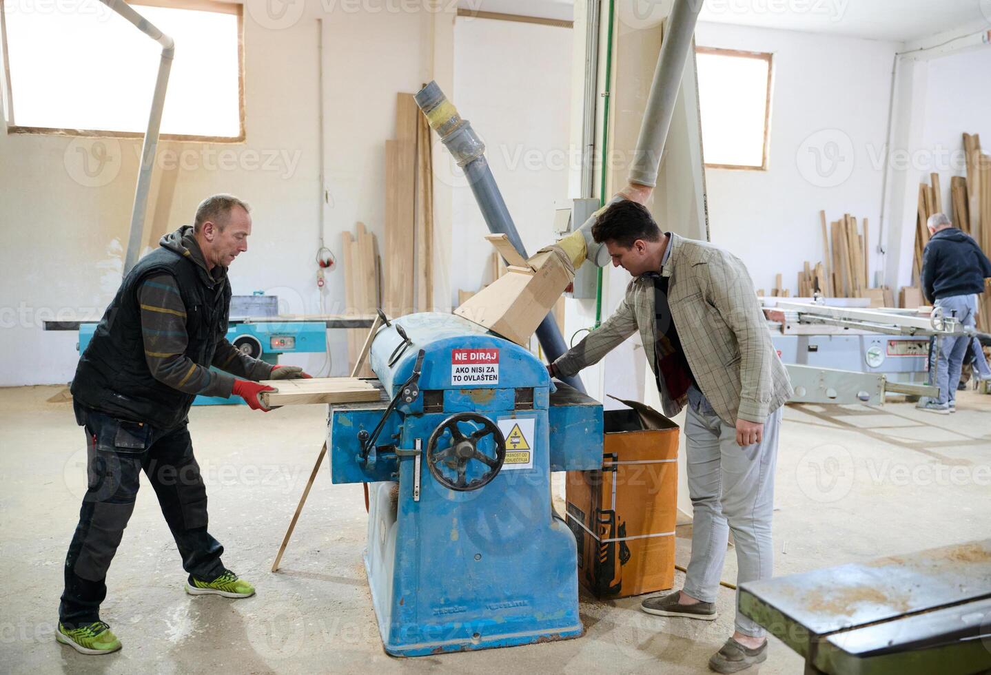 Production Manager Demonstrating Woodcraft Techniques to Employee for Decorative and Residential Items photo