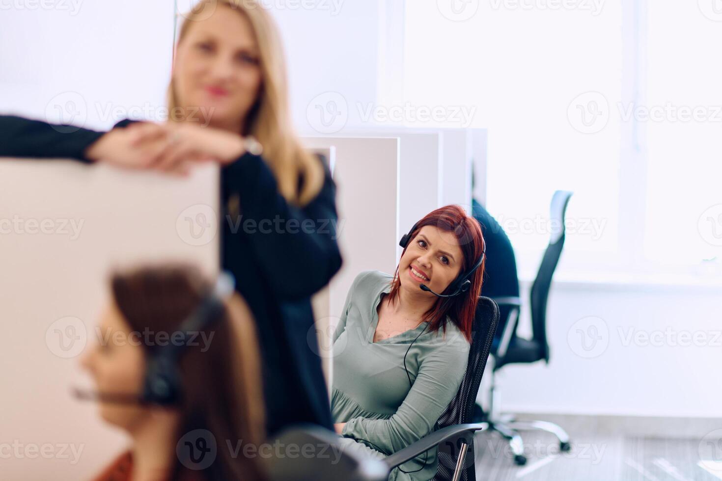 Team of Women Providing Customer Support in Call Center Environment. photo