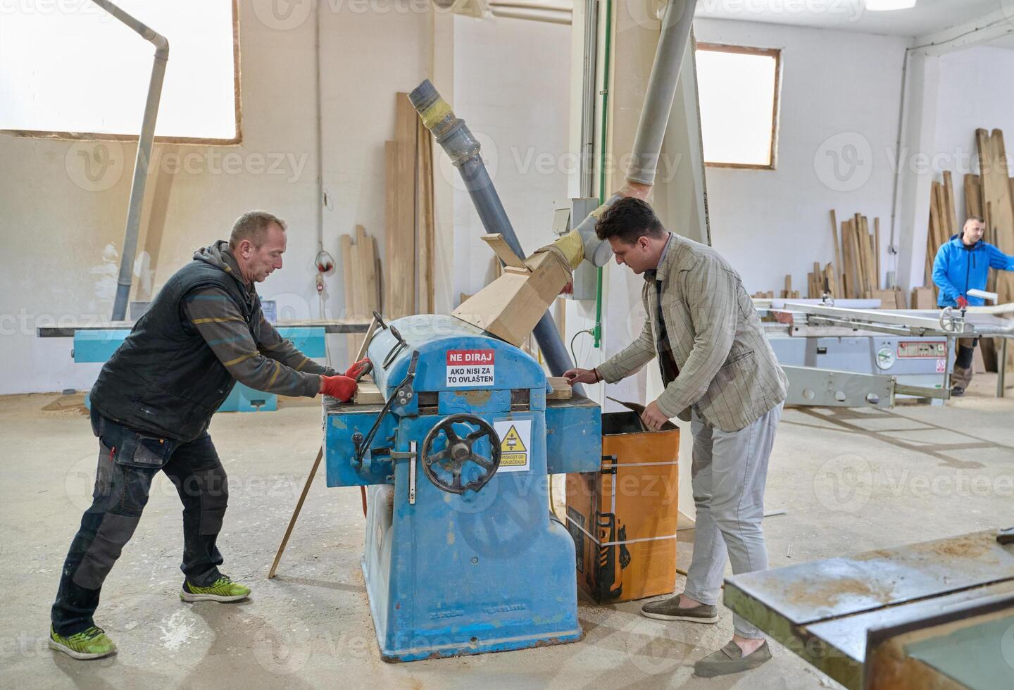 Production Manager Demonstrating Woodcraft Techniques to Employee for Decorative and Residential Items photo