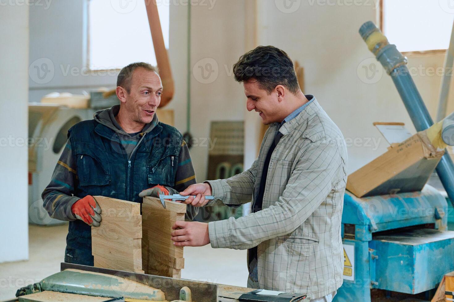 Production Manager Demonstrating Woodcraft Techniques to Employee for Decorative and Residential Items photo