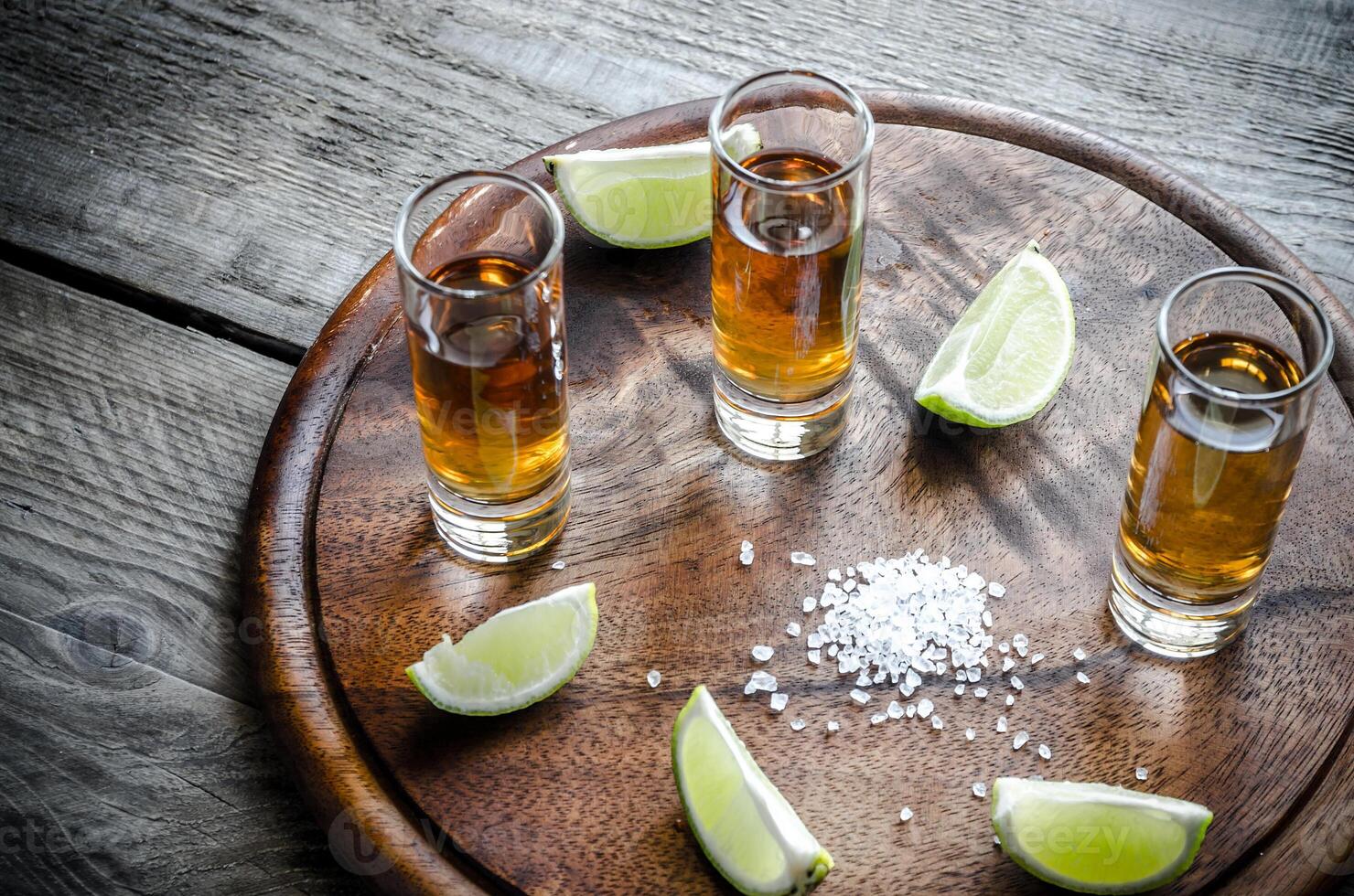 Glasses of tequila on the wooden board photo