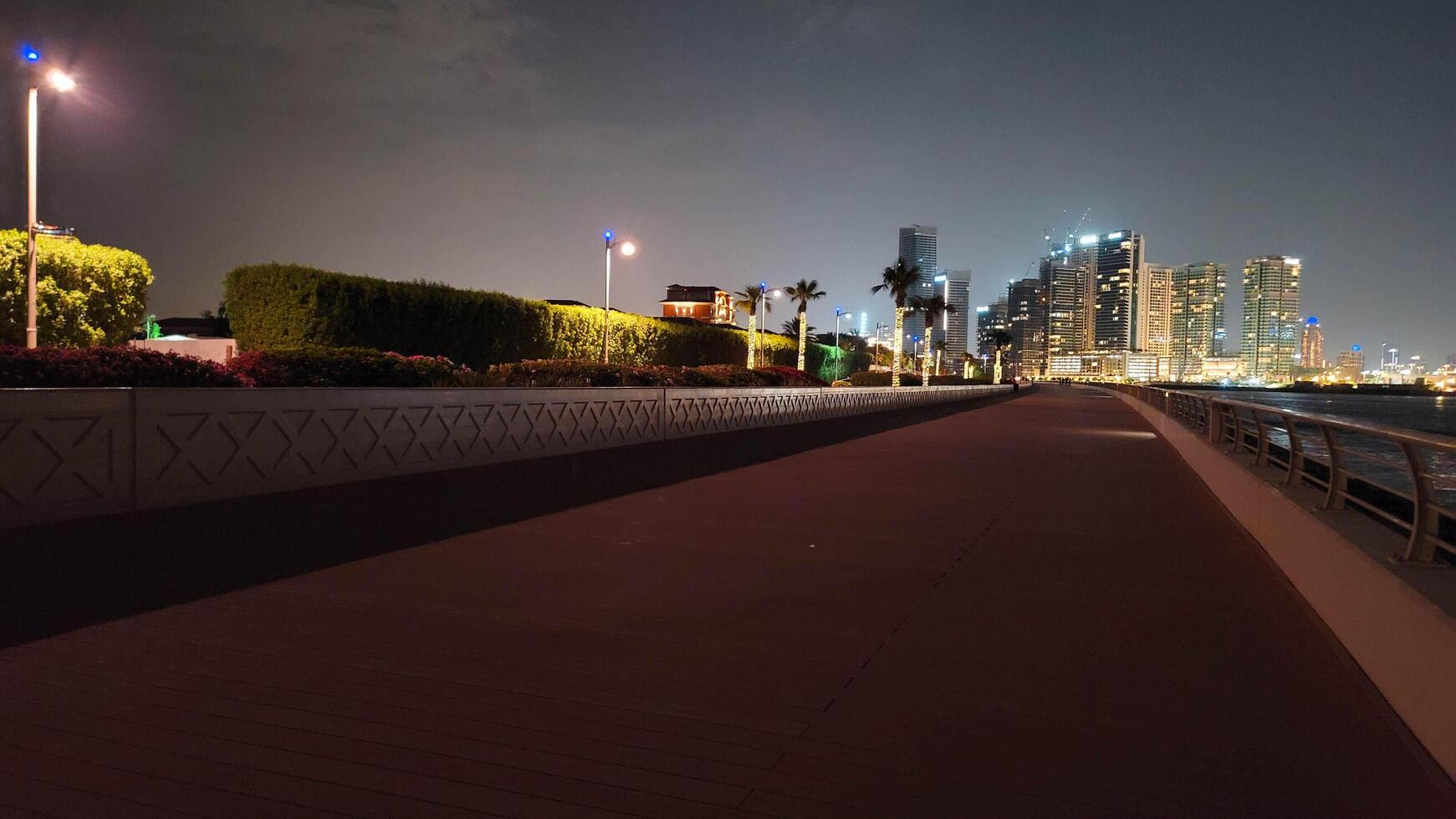 palm jumeirah cityscape with river in the night view photo