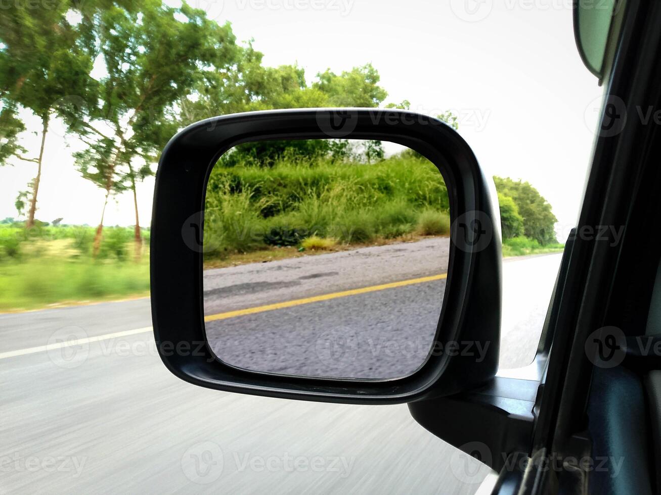 Car Rear Mirror View while driving photo