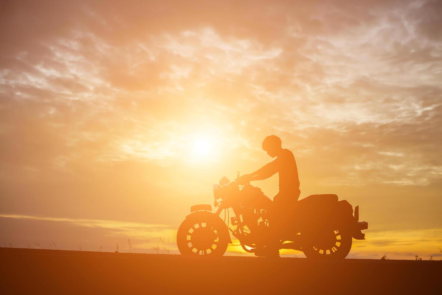 Man biker over sunset photo