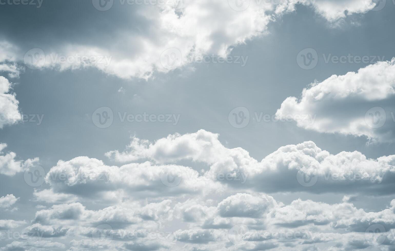 Dramatic overcast sky with gray clouds forming moody and tranquil backdrop before rain, capturing the serene yet stormy atmosphere in the cloudy weather of the rainy season. Moody and peaceful scene. photo